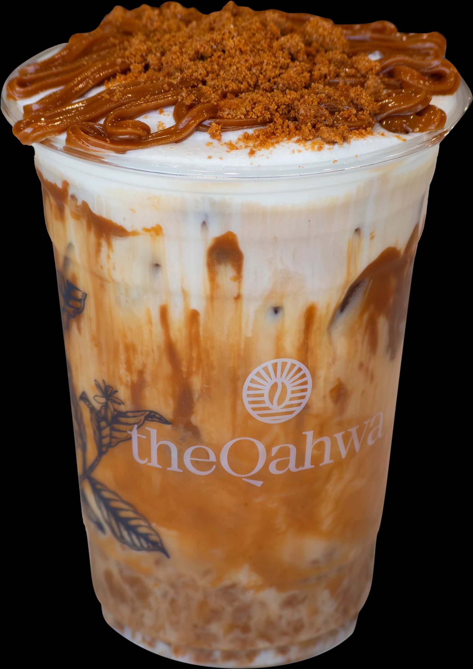 Iced Biscoff Latte in a clear theQahwa cup — espresso and milk swirled with cookie butter, finished with whipped cream, a Biscoff drizzle, and crumbled cookie on top.