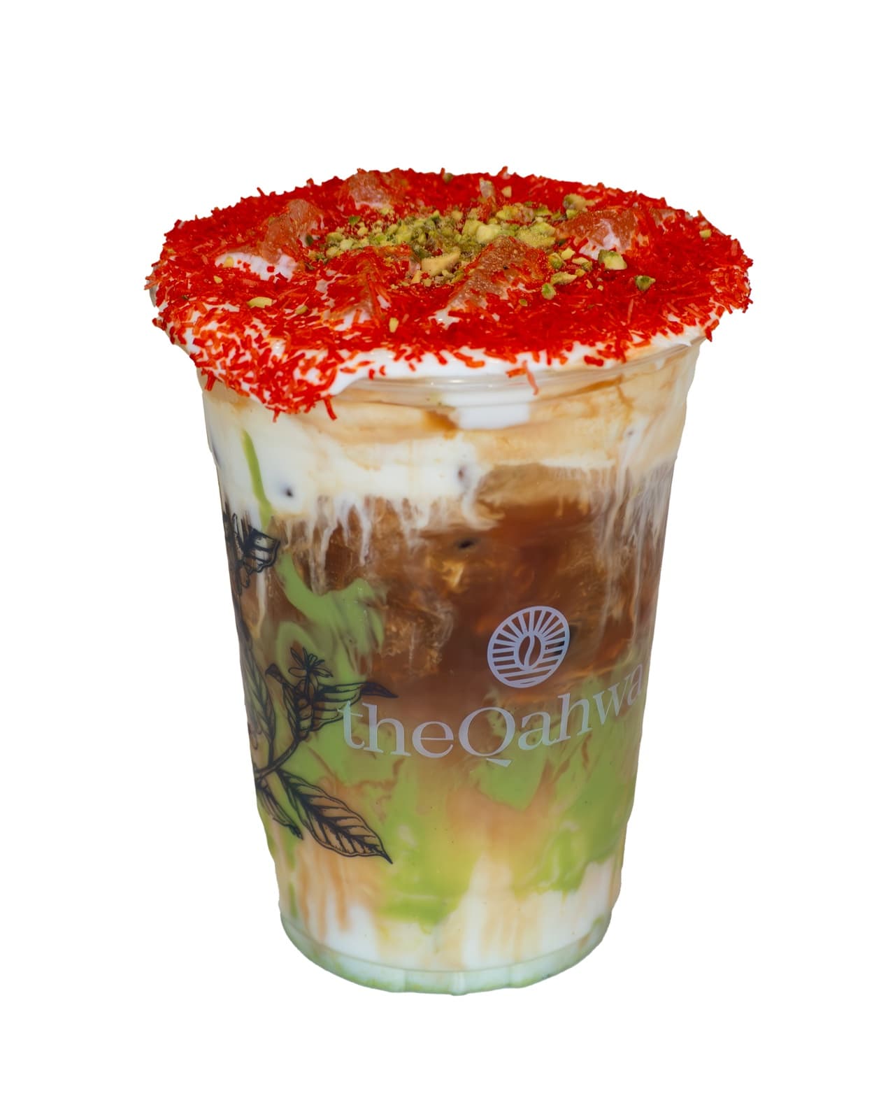 Iced Knafeh Latte in a clear theQahwa cup — pistachio cream and espresso layered beneath a soft milk top, rimmed with red-dusted toasted kataifi and crushed pistachio.