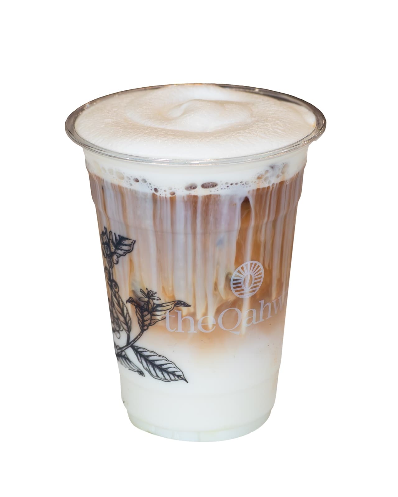 Iced Banana Latte in a clear theQahwa cup — espresso and milk over ice with banana cream layered through the middle, finished with a thick whipped-cream cap.