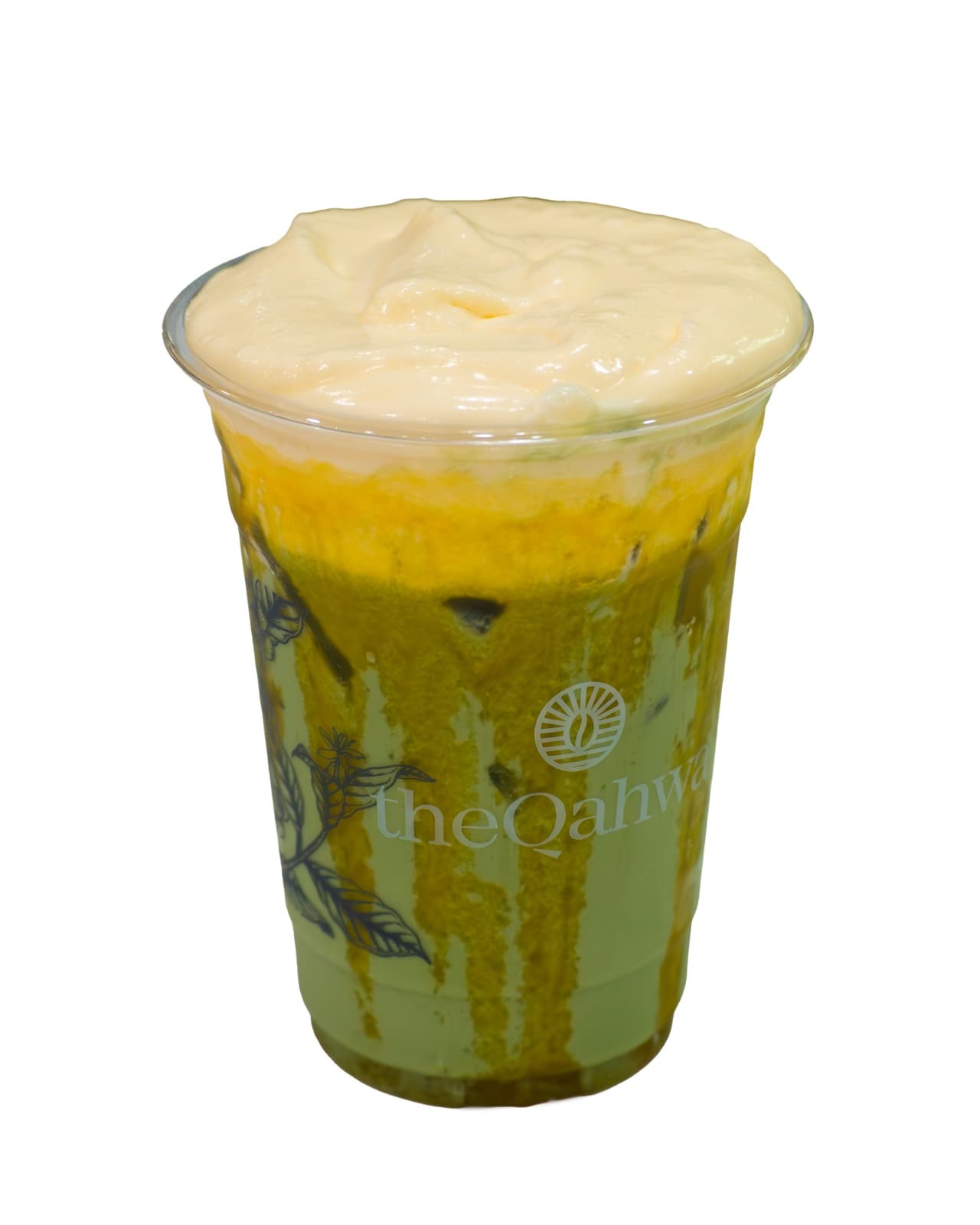 Mango Coconut Matcha in a clear theQahwa cup — vibrant green matcha layered with golden mango puree under a creamy coconut foam top.